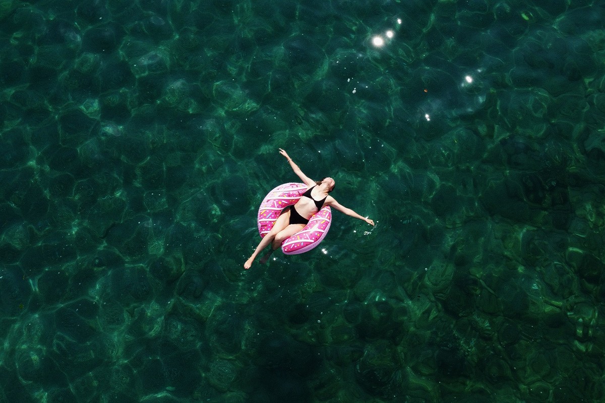 Frau mit Schwimmreifen im Meer